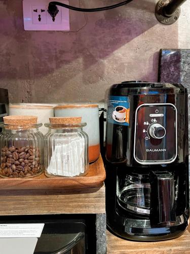 a coffee maker sitting on top of a counter with coffee beans at CLOCKWORKORANGE Luxury Suites 4-Minutes Away To Airport in Mactan