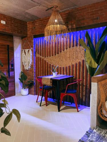 a dining room with a table and two chairs at CLOCKWORKORANGE Luxury Suites 4-Minutes Away To Airport in Mactan