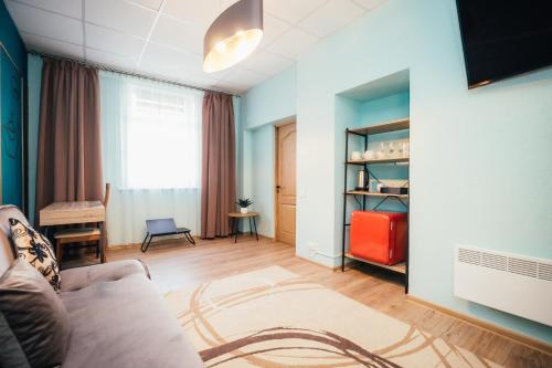 a living room with a couch and a table at La Casa in Ventspils