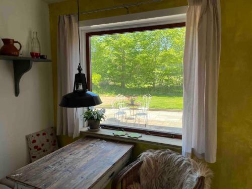 a window in a room with a bench and a table at The Old Soap House - stylish and close to beach in Vang