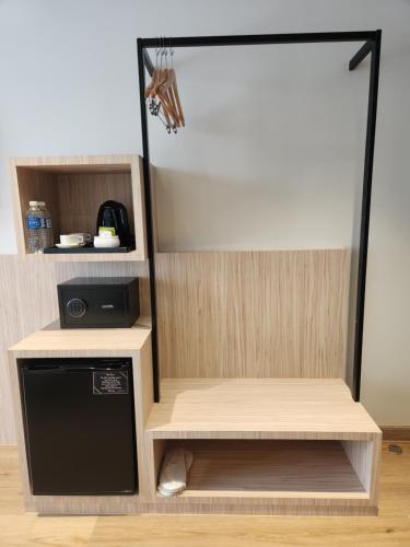 a kitchen with a refrigerator and a dishwasher at Hotel Marudu Inn in Pingan Pingan