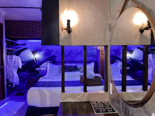 a room with a bed and a mirror in it at CLOCKWORKORANGE Luxury Suites 4-Minutes Away To Airport in Mactan