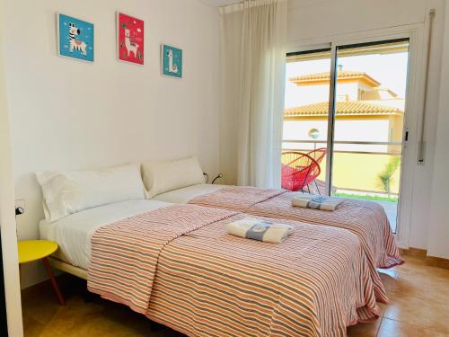 a bedroom with a bed with two towels on it at Playa Pals Sea View - Plus Costa Brava in Pals