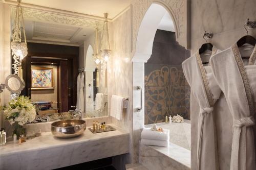 a bathroom with a tub and a sink and a mirror at Jumeirah Zabeel Saray Dubai in Dubai
