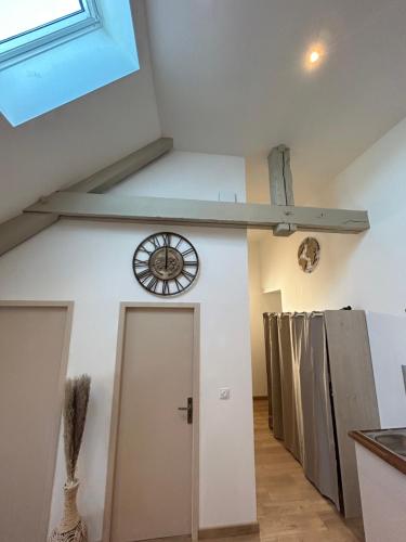 a room with a clock on the wall and a door at Blum in Brive-la-Gaillarde