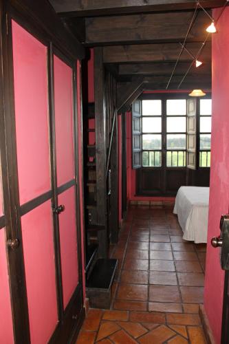 a room with pink sliding doors and a bed at Globales Playa de Las Llanas in Muros de Nalón