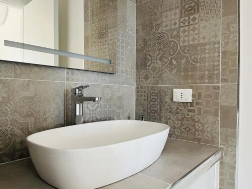 a bathroom with a white tub and a mirror at Eufonia del Mare in Finale Ligure