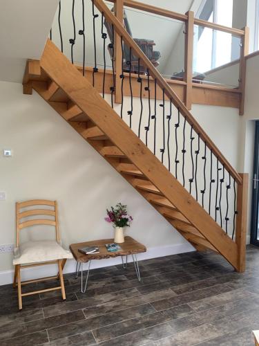 a staircase with a chair and a table at Newton Bothy in Stirling