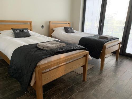 two beds sitting next to each other in a room at Newton Bothy in Stirling