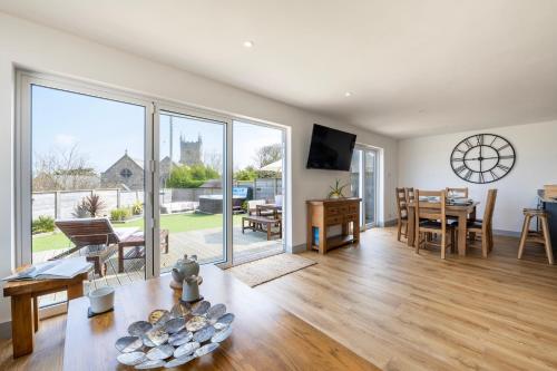 a living room with a table and a dining room at Carbis Bay and Spa Hotel in St Ives
