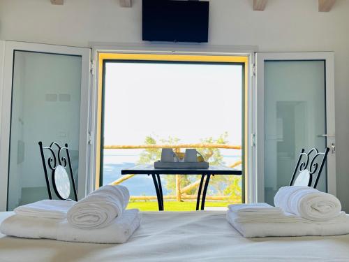 a bedroom with a bed with a view of a table at Eufonia del Mare in Finale Ligure