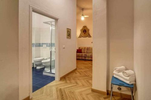 a bathroom with a toilet and a walk in shower at Piazza Mentana Apartment in Florence
