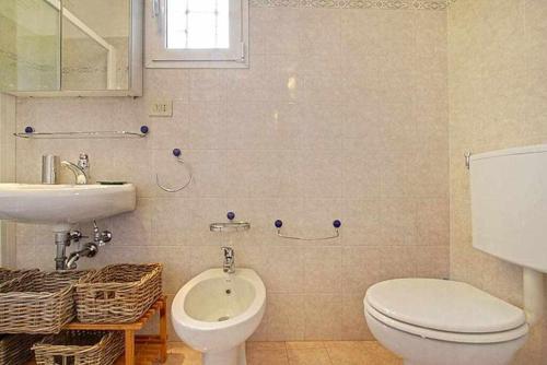 a bathroom with a toilet and a sink at Solaris Apartment With Two Bedrooms in Florence