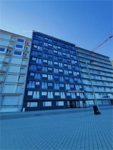 a tall building with a crane in front of it at Lovely n° 9 op ieder moment een prachtig zeezicht & zwembad in Middelkerke