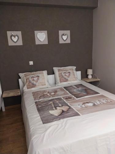 a bedroom with a large bed with shoes on it at Lovely n° 9 op ieder moment een prachtig zeezicht & zwembad in Middelkerke