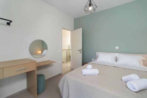 a bedroom with a bed with two towels on it at Lamzi's Residence in Chania Town