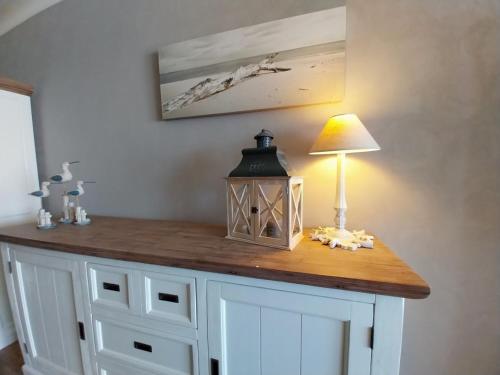 a table with a lamp on top of it at Lovely n° 9 op ieder moment een prachtig zeezicht & zwembad in Middelkerke