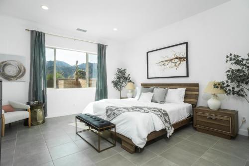 a bedroom with a bed and a chair and a window at Spectacular PGA West New Home! in La Quinta