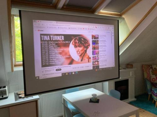 a large projection screen with a woman on it at Retro Apartment Graz in Graz