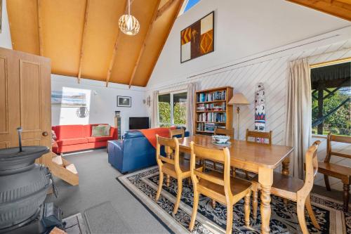 a living room with a wooden table and chairs at Moore in Turangi in Turangi