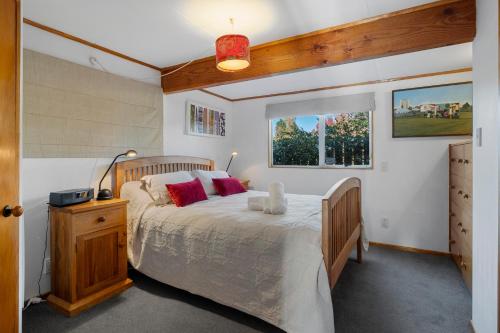 a bedroom with a large bed and a window at Moore in Turangi in Turangi