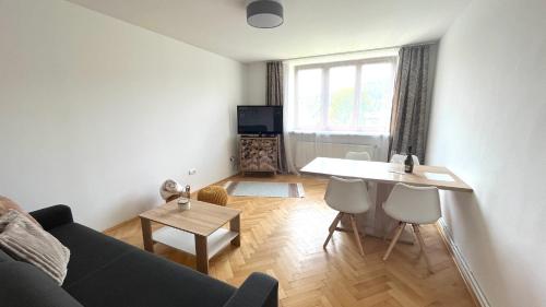 a living room with a couch and a table at Apartmán Deštné v Orlických horách 58 in Deštné v Orlických horách