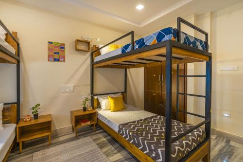 a bedroom with two bunk beds in a room at Zostel Visakhapatnam (Vizag) in Visakhapatnam