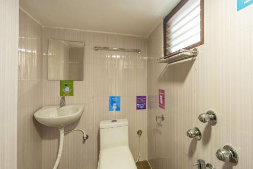 a bathroom with a toilet and a sink at Zostel Visakhapatnam (Vizag) in Visakhapatnam