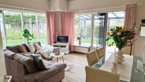 un soggiorno con divano e TV di Nordseeperle Nordholland, mit Sauna, Dirkshorn a Dirkshorn