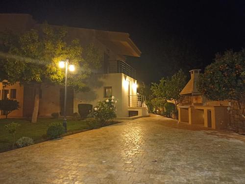 a street light in front of a house at night at Seaside retreat house in Paralía Sergoúlas