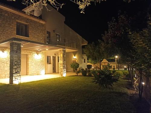 a house at night with lights on the yard at Seaside retreat house in Paralía Sergoúlas