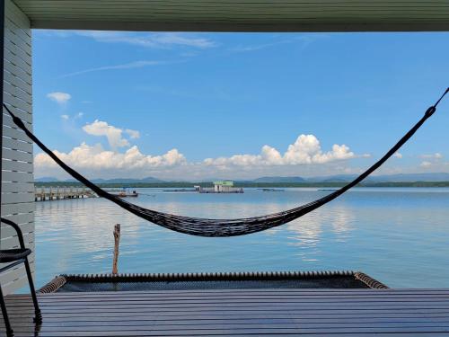 a hammock on a porch with a view of the water at Satun Sea Balcony in Ban Tanjong In