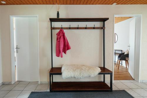 a coat hanging on a shelf in a room at Ferienwohnung - 100m von der Talstation Aletsch Bahnen und Bahnhof Fiesch, BESTE Ausgangslage in Fiesch