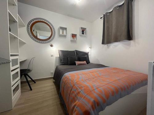 a bedroom with a bed and a mirror on the wall at Appartement 2 pièces Antibes Mer - Piscine, Parking, Tennis, Wifi… in Antibes