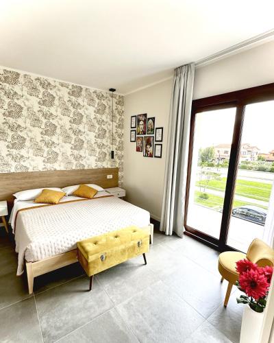 a bedroom with a bed and a large window at Karasole in San Teodoro