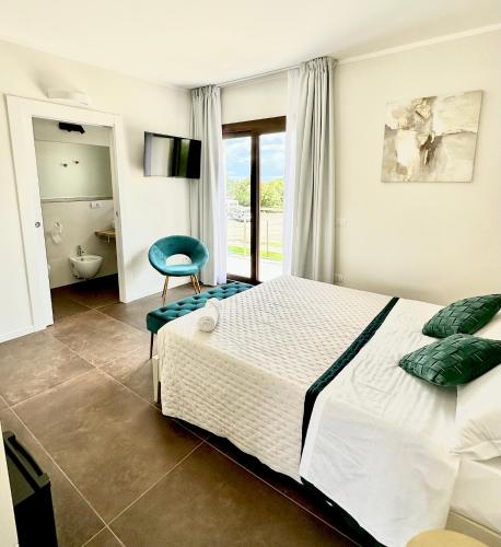 a bedroom with a bed and a blue chair at Karasole in San Teodoro