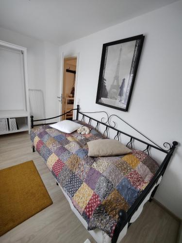 a bedroom with a bed with a quilt on it at Apartment Lia in Beerfelden