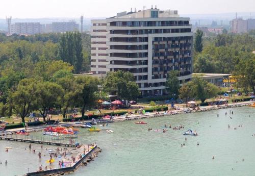 a group of people in the water at a beach at ‘Good Feelings’ in Siófok