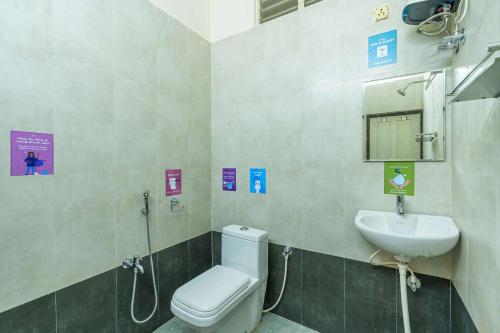 a bathroom with a toilet and a sink at Zostel Visakhapatnam (Vizag) in Visakhapatnam