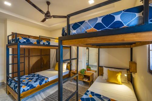 a bedroom with two bunk beds in a room at Zostel Visakhapatnam (Vizag) in Visakhapatnam