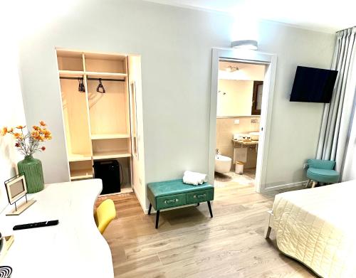 a living room with a bed and a room with a mirror at Karasole in San Teodoro