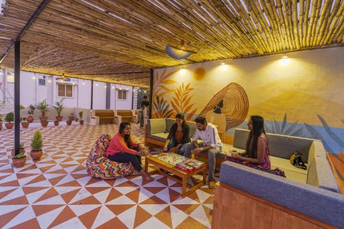 a group of people sitting in a lobby at Zostel Visakhapatnam (Vizag) in Visakhapatnam