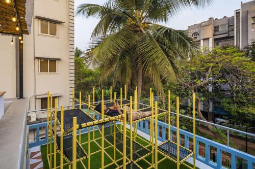 a playground on the roof of a building with a palm tree at Zostel Visakhapatnam (Vizag) in Visakhapatnam