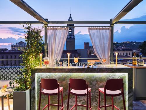 a bar on a balcony with a view of the city at Vista Palazzo in Verona