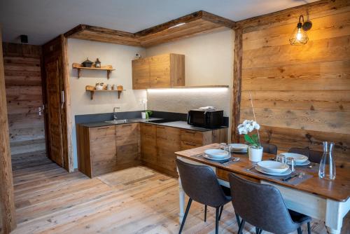 a kitchen with a table with chairs and a sink at Residenza dell'Aquila - appartamento in Vezza dʼOglio