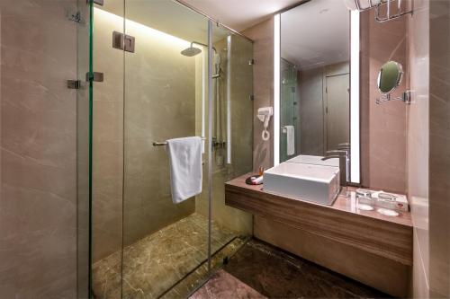 a bathroom with a sink and a glass shower at Aber Abha in Abha