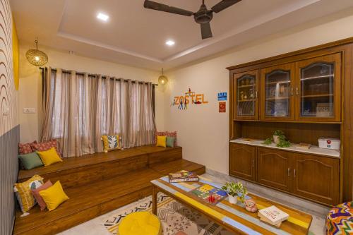 a living room with a couch and a table at Zostel Visakhapatnam (Vizag) in Visakhapatnam