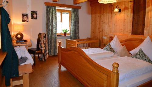 a bedroom with two beds and a desk and a window at Wenzlhof in Zwiesel
