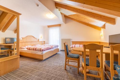 A bed or beds in a room at Albergo Canazei