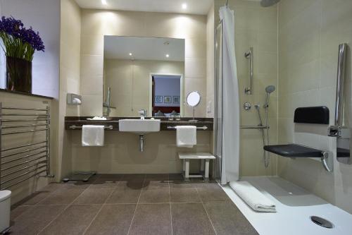 a bathroom with a sink, toilet and bathtub at The Rembrandt in London